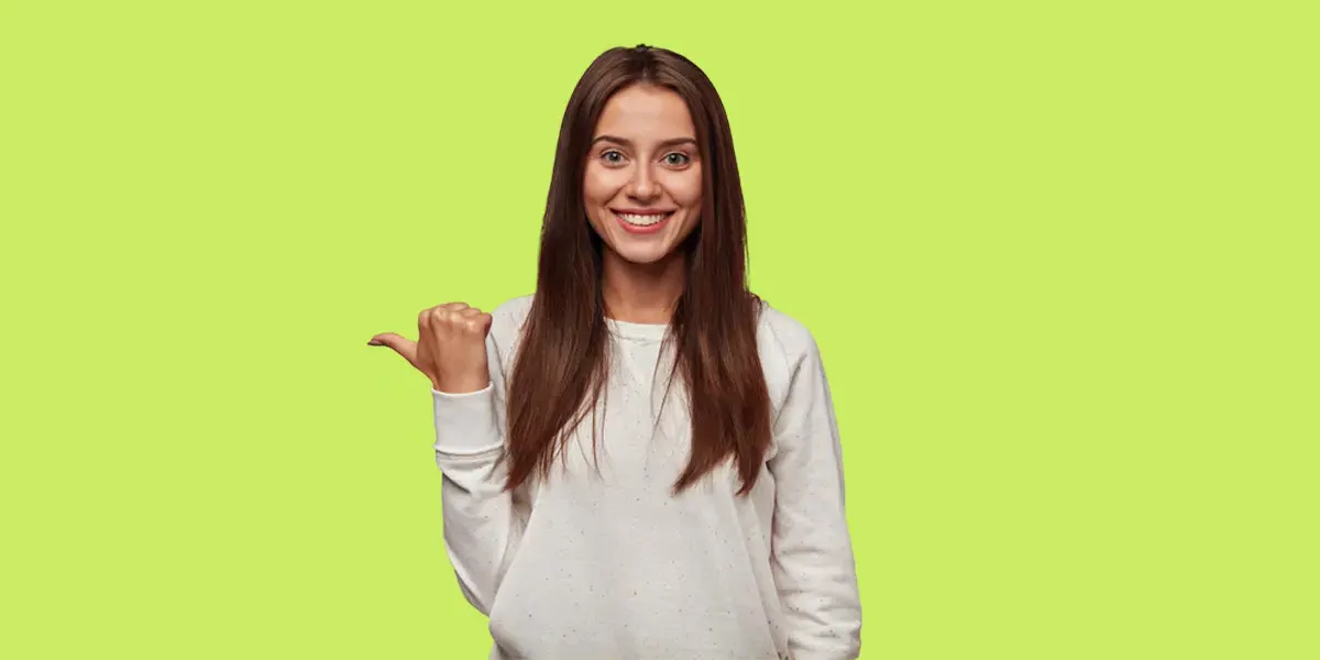 Smiling woman pointing to the side on a green background for Retouchaid pricing page.
